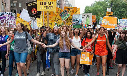 students marching with signs oregon sustainability climate action